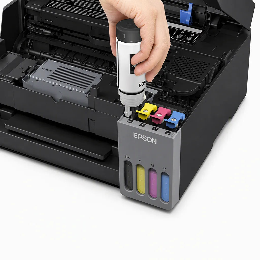 Close-up of the Epson EcoTank L5390 spill-free ink refill system showing an Epson ink bottle being refilled into the integrated EcoTank reservoirs for easy and mess-free ink replacement.