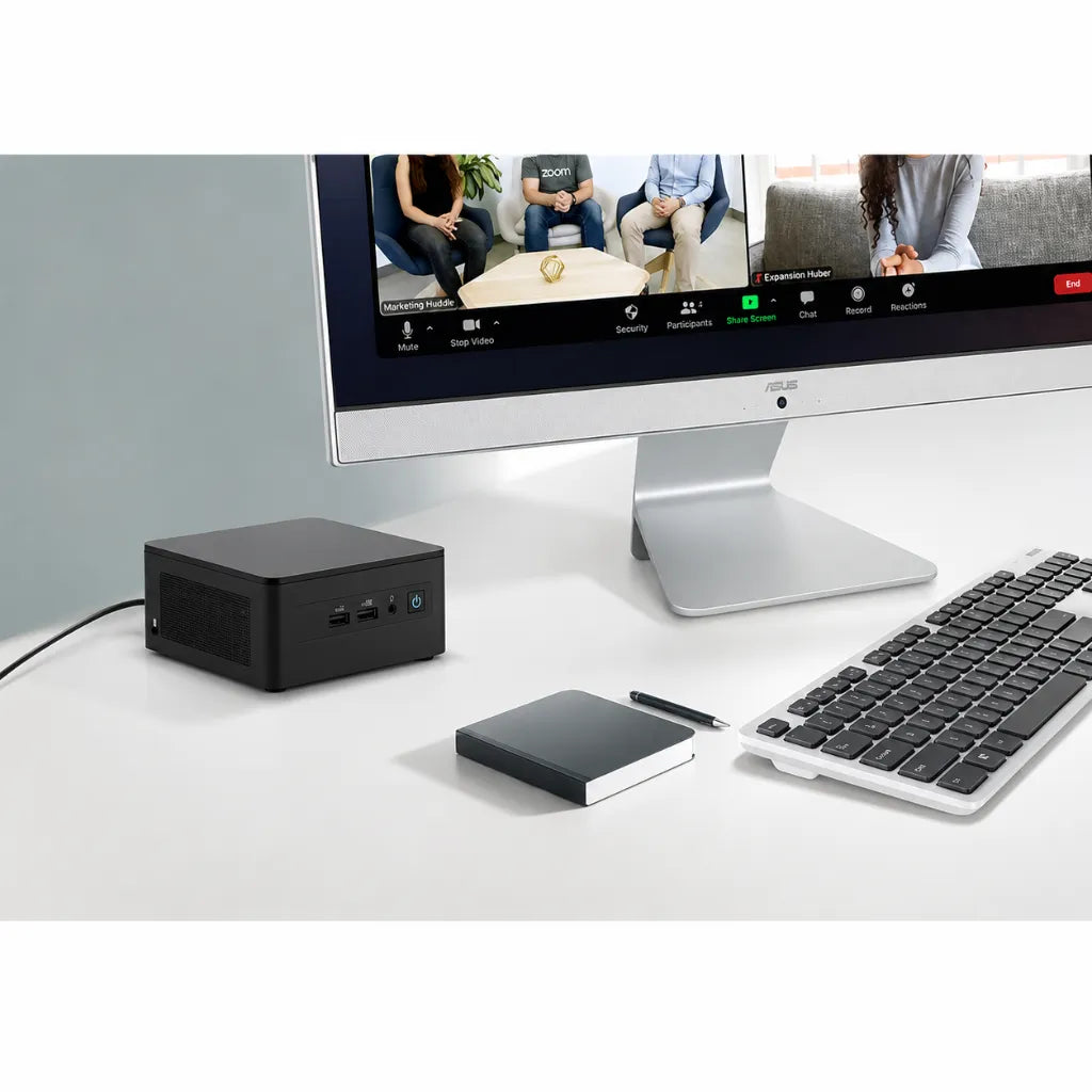 ASUS NUC 13 Pro NUC13ANHi7 compact mini PC in a modern office workstation connected to an external monitor.