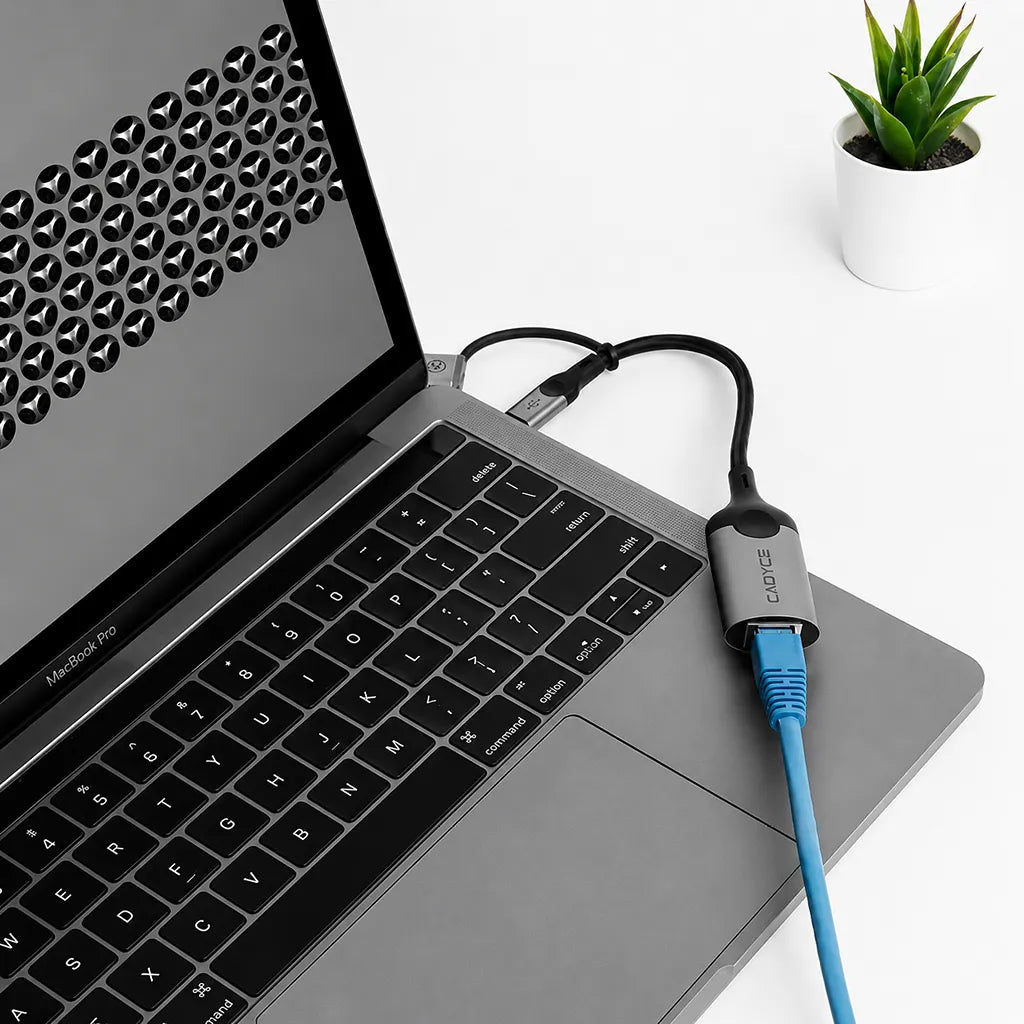 Cadyce CA-CU1000 USB-A and USB-C Gigabit Ethernet Adapter connected to a laptop with RJ45 Ethernet cable for stable wired internet -tpstech.in
