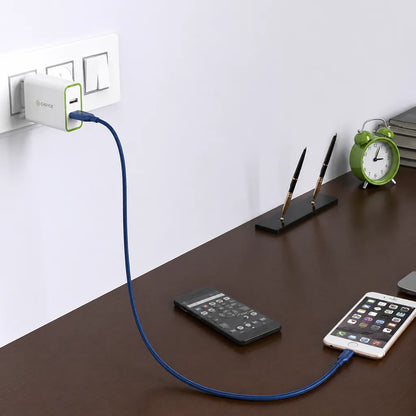 Cadyce CA-DUWC 30W Dual USB Wall Charger in home setup charging a smartphone with Quick Charge 3.0 and Smart Charging