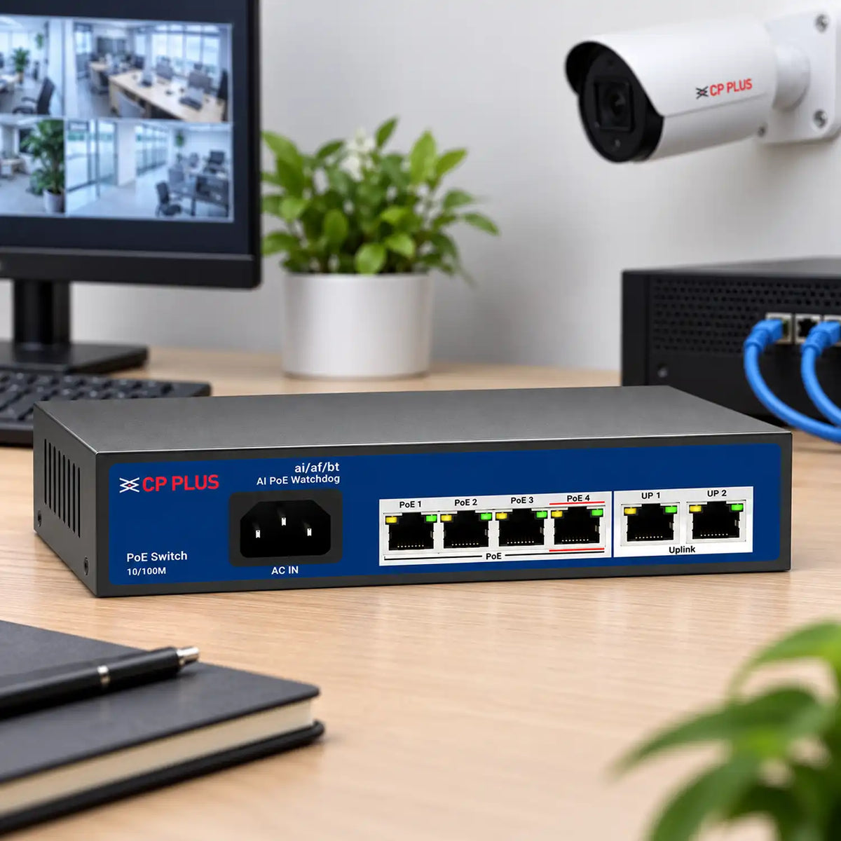CP PLUS CP-ANW-HP4H2-N65 4-Port PoE Switch on Office Desk Setup with CCTV Camera and Monitoring Screen -tpstech.in