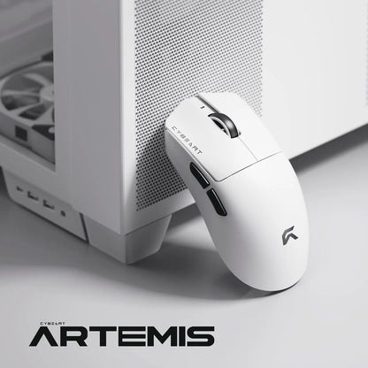 Cybeart Artemis 52g Ultra-Light Wireless Gaming Mouse - White resting next to a white desktop cabinet -tpstech.in