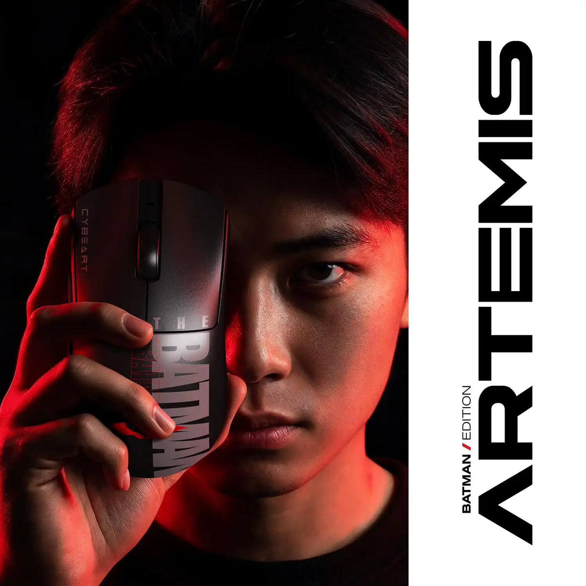 Gamer holding Cybeart Artemis The Batman 52g Ultra-Light Wireless Gaming Mouse covering eye with red lighting -tpstech.in
