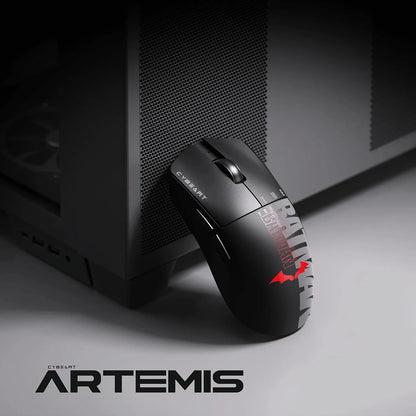 Cybeart Artemis The Batman 52g Ultra-Light Wireless Gaming Mouse placed beside a dark PC case -tpstech.in