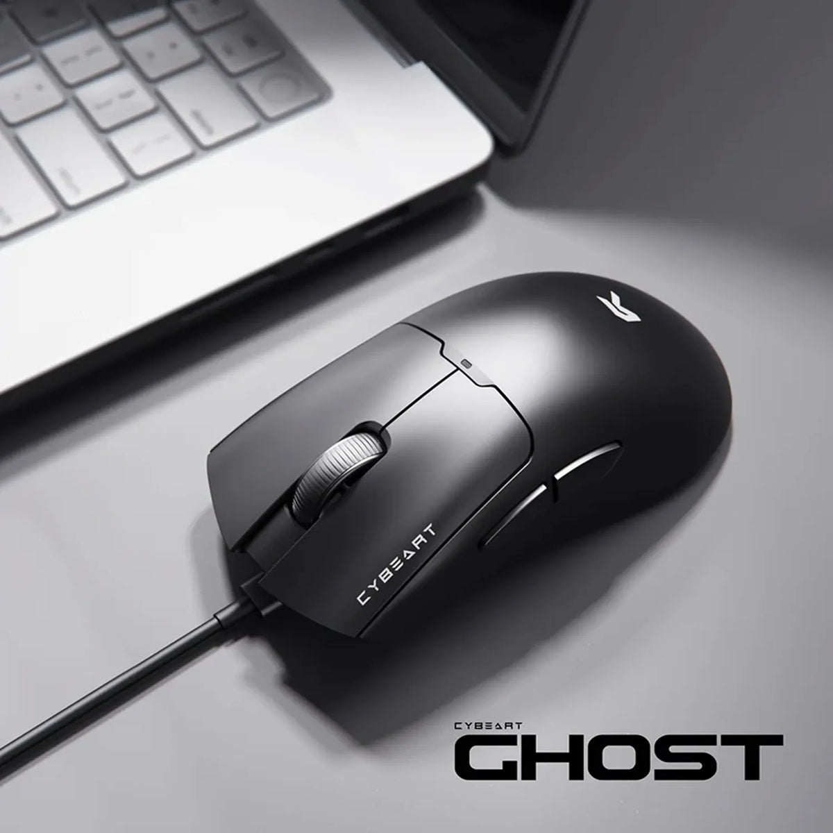 Cybeart Ghost 49g Ultra-light Wired Gaming Mouse placed on desk setup beside laptop -tpstech.in