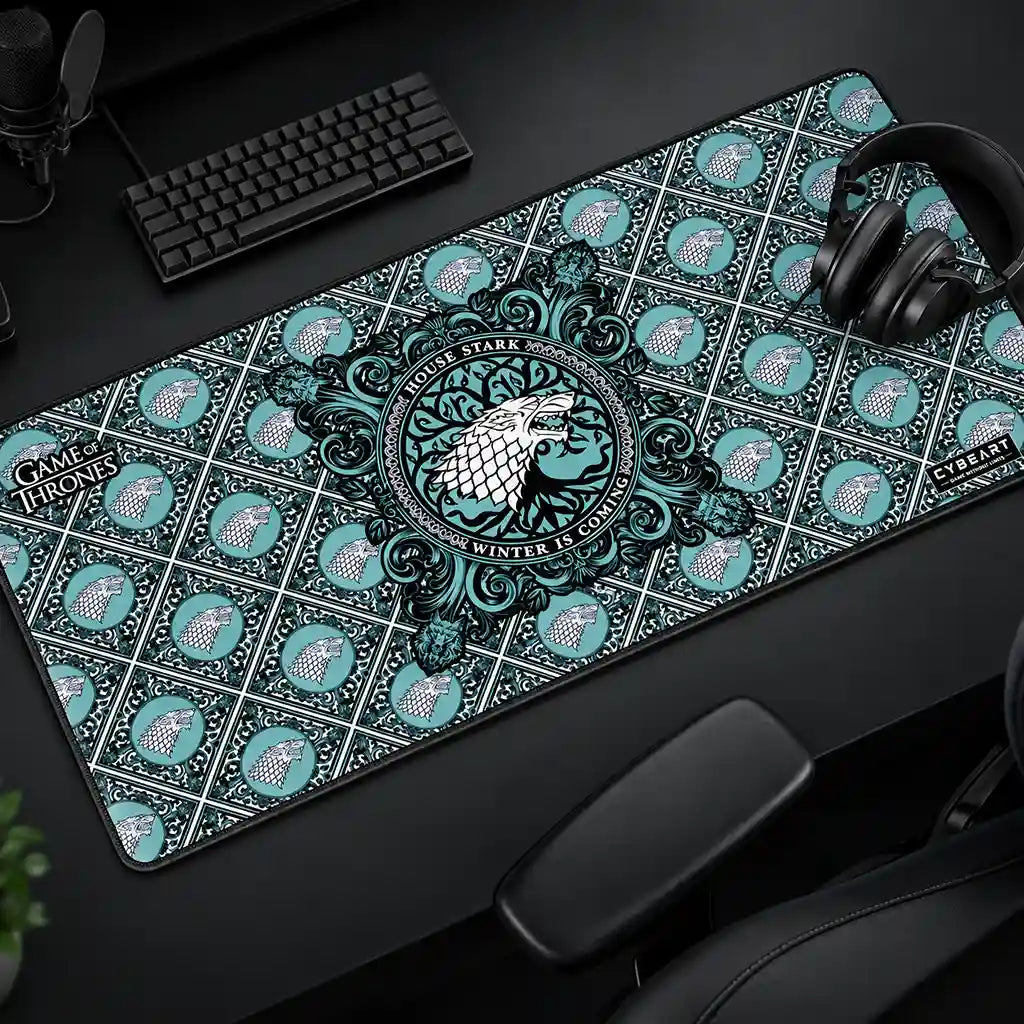 Cybeart House Stark XXL Gaming Desk Mat Waterproof placed on gaming desk setup with keyboard and headphones -tpstech.in