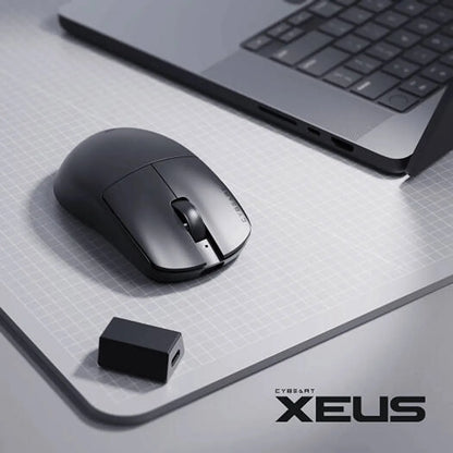 Cybeart Xeus Ultra-Light Wireless Gaming Mouse 8K Tri-Mode on desk mat beside laptop and 8K wireless dongle receiver -tpstech.in