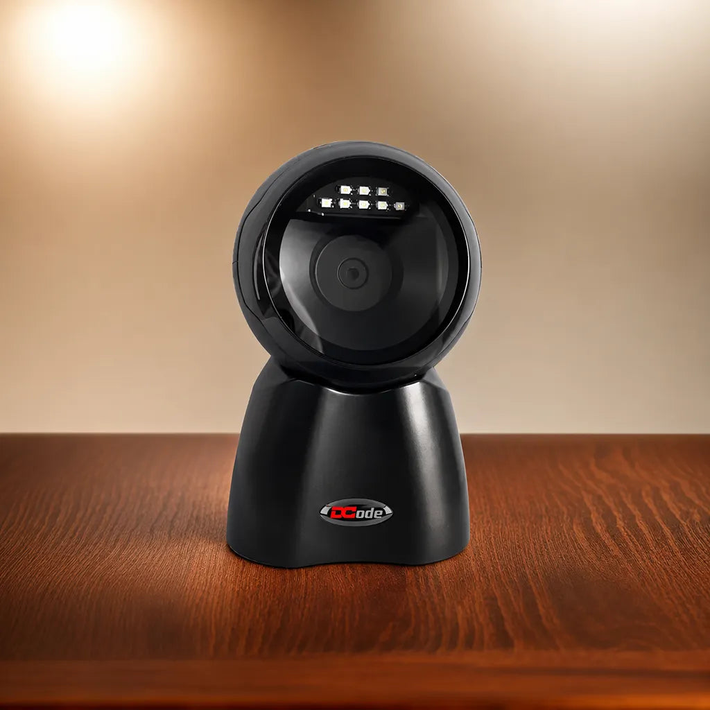 Dcode DC7132 hands-free desktop barcode scanner on a wooden desk for retail, pharmacy, and POS billing environments.