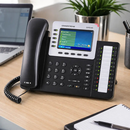 Grandstream GXP2160 enterprise IP phone on an office desk featuring a 4.3-inch color display, HD audio handset, and programmable BLF keys for business communication.