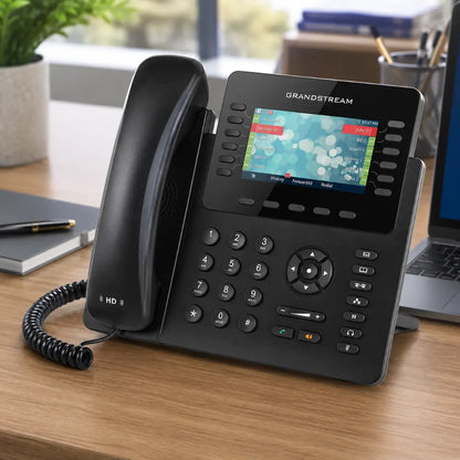 Grandstream GXP2170 enterprise IP phone with color display and programmable keys placed on an office desk for business VoIP communication.