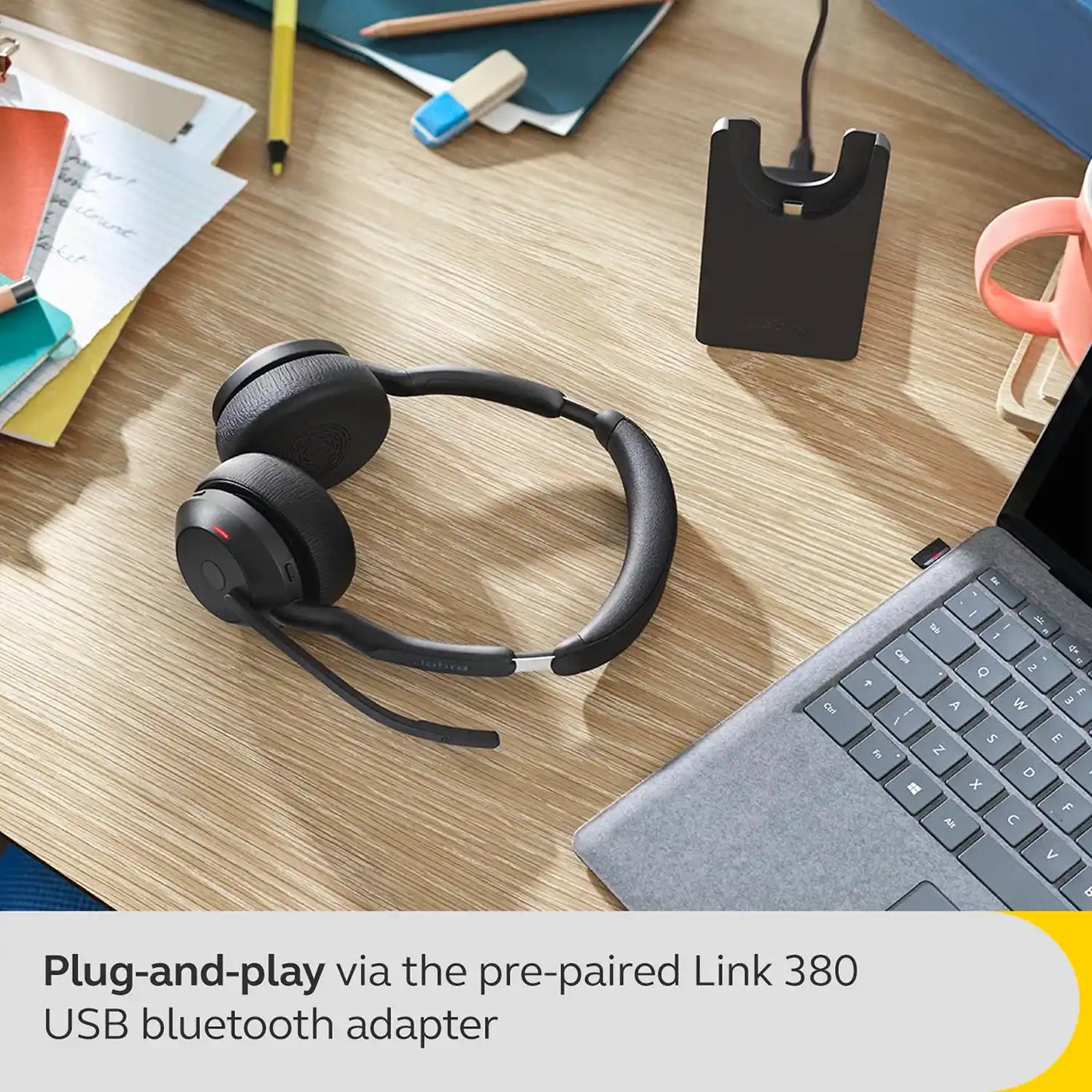 Jabra Evolve2 55 MS Bluetooth Headset next to laptop with plug and play Link 380 USB adapter -tpstech.in