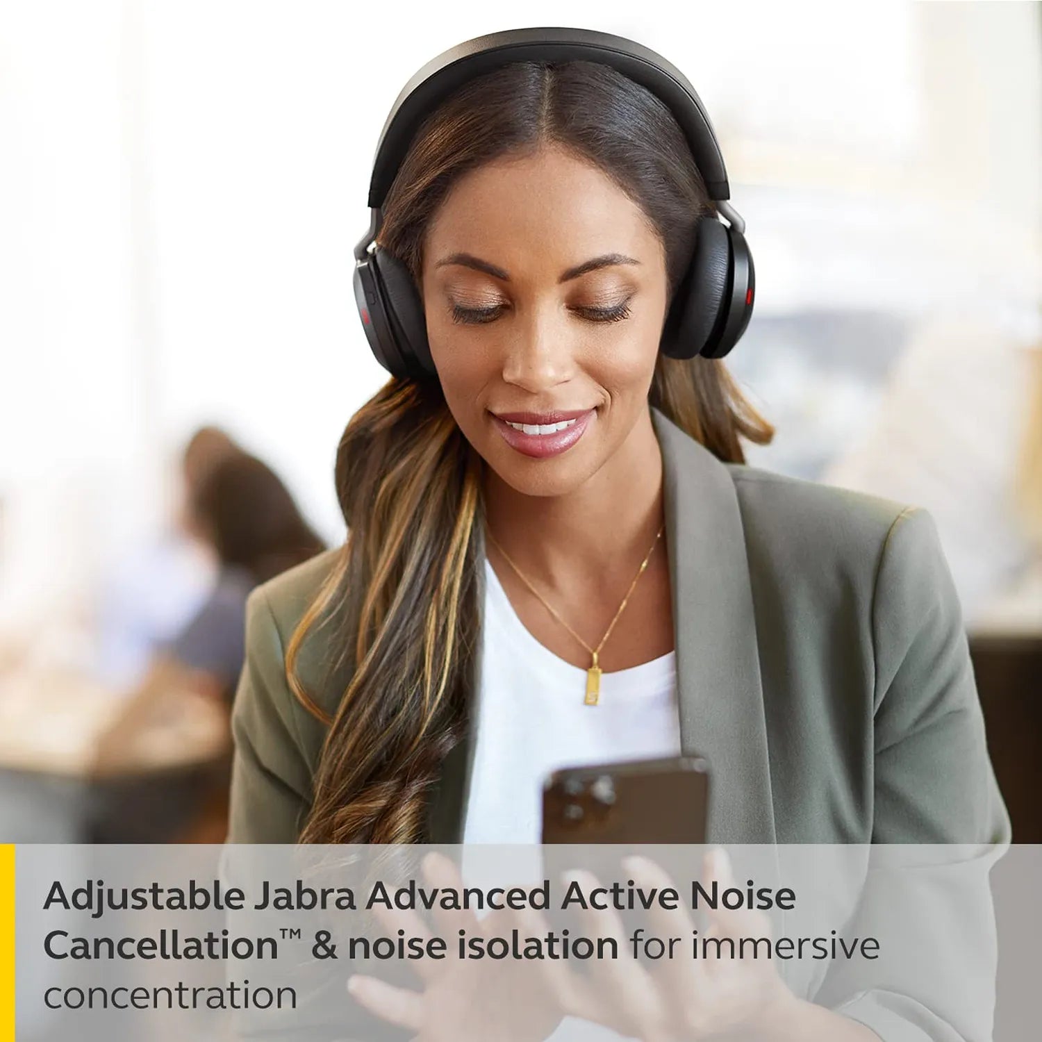 Woman using smartphone while wearing Jabra Evolve2 75 UC Stereo Wireless Headset with Advanced Active Noise Cancellation -tpstech.in