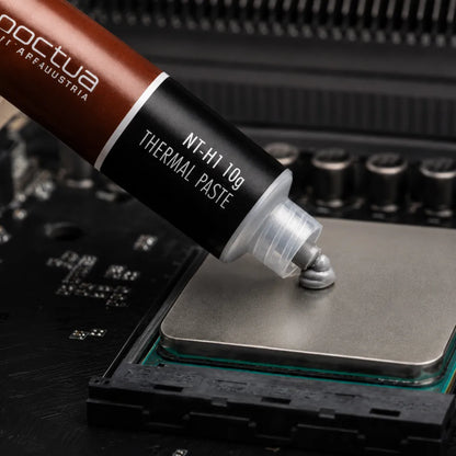 Close-up of Noctua NT-H1 10g thermal compound applied on a processor for high-performance CPU cooling.