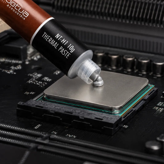 Noctua NT-H1 10g thermal paste being applied to a desktop CPU for efficient heat transfer and cooling performance.