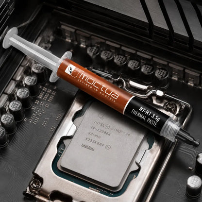 Noctua NT-H1 3.5g thermal paste syringe placed on an Intel desktop processor inside a motherboard.