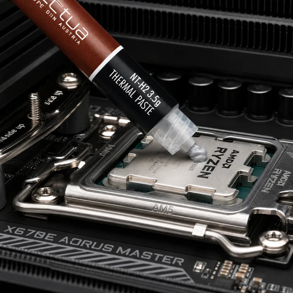 Applying Noctua NT-H2 3.5g AM5 Edition thermal paste on an AMD Ryzen AM5 processor for efficient CPU cooling.