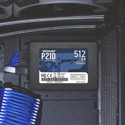 Patriot P210 512GB 2.5 Inch SATA III Internal SSD mounted inside desktop PC chassis drive bracket with blue cables -tpstech.in