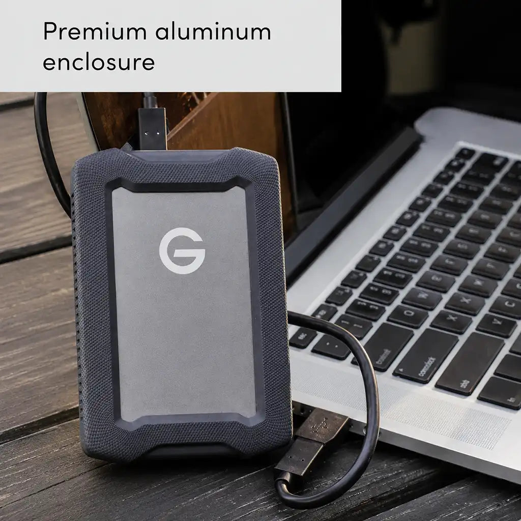 Western Digital G-DRIVE ArmorATD 2TB connected to a laptop, highlighting its premium aluminum enclosure and USB-C connectivity.
