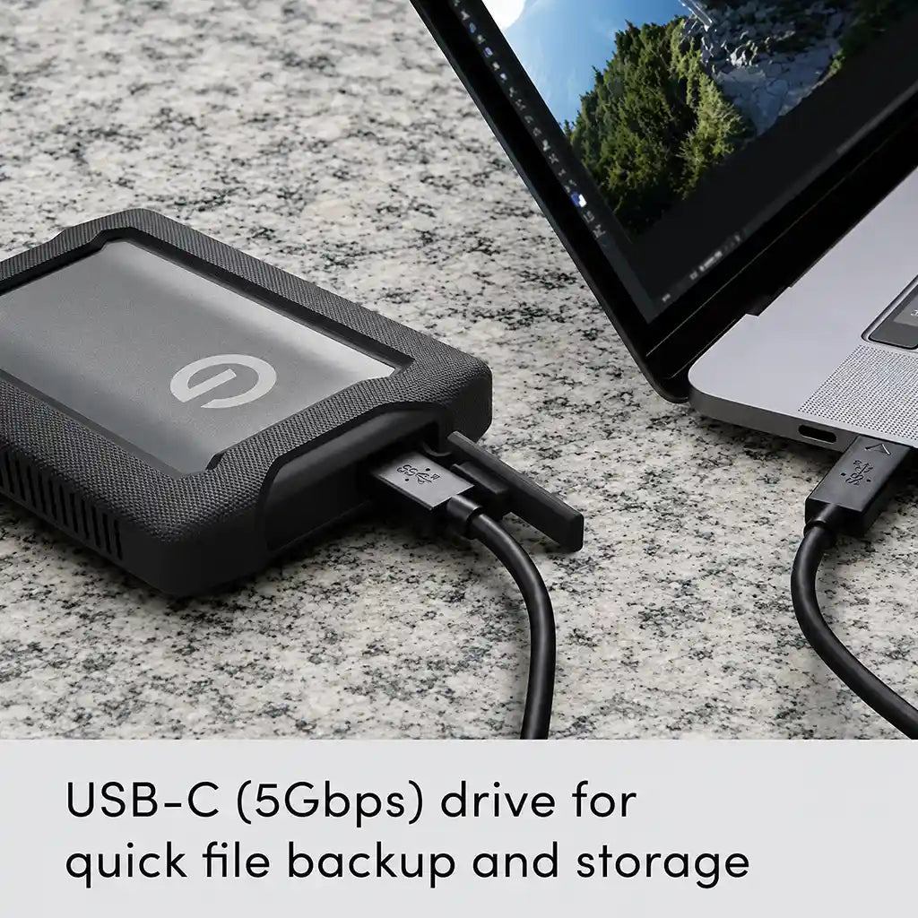 Western Digital G-DRIVE ArmorATD 2TB portable hard drive connected via USB-C for fast file backup and external storage.