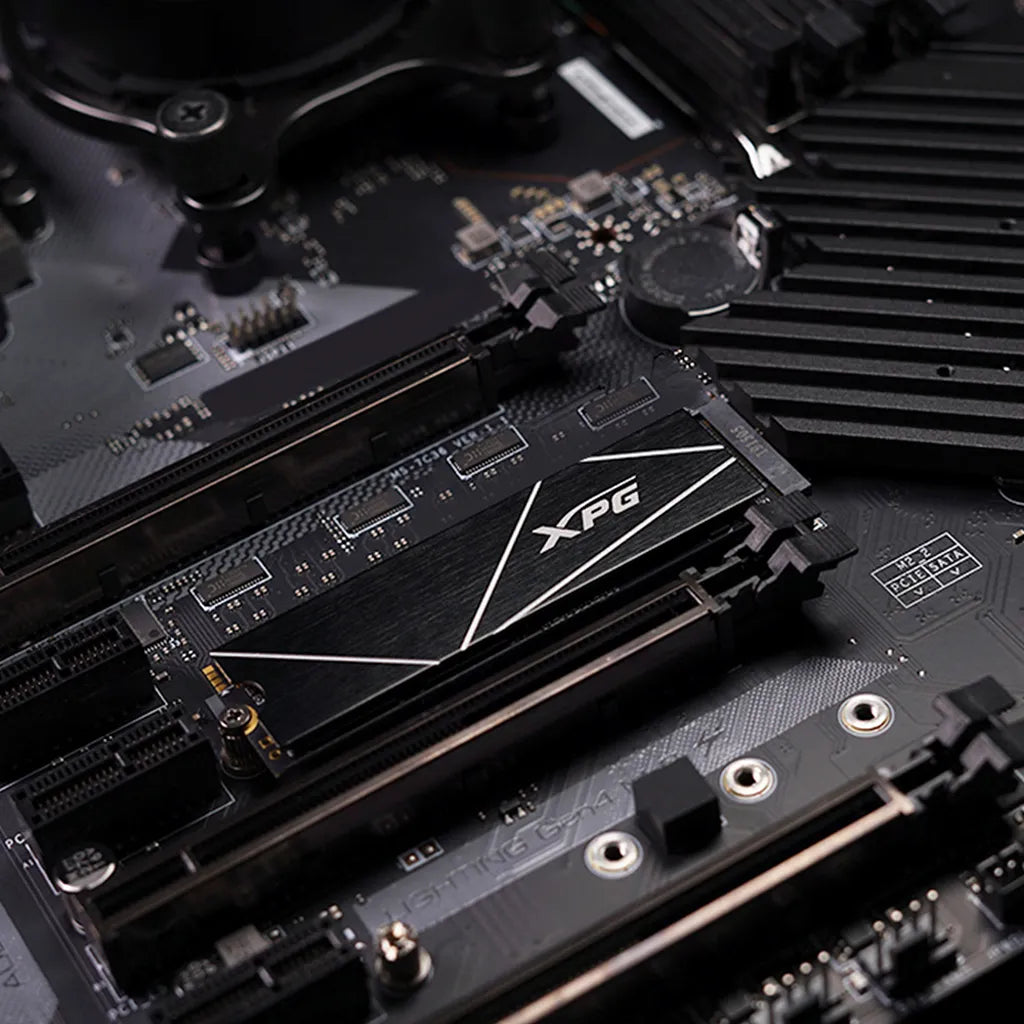 Close-up of XPG GAMMIX S70 Blade 8TB PCIe Gen4 NVMe M.2 2280 SSD installed on a gaming motherboard.