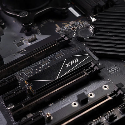 Close-up of XPG GAMMIX S70 Blade 8TB PCIe Gen4 NVMe M.2 2280 SSD installed on a gaming motherboard.